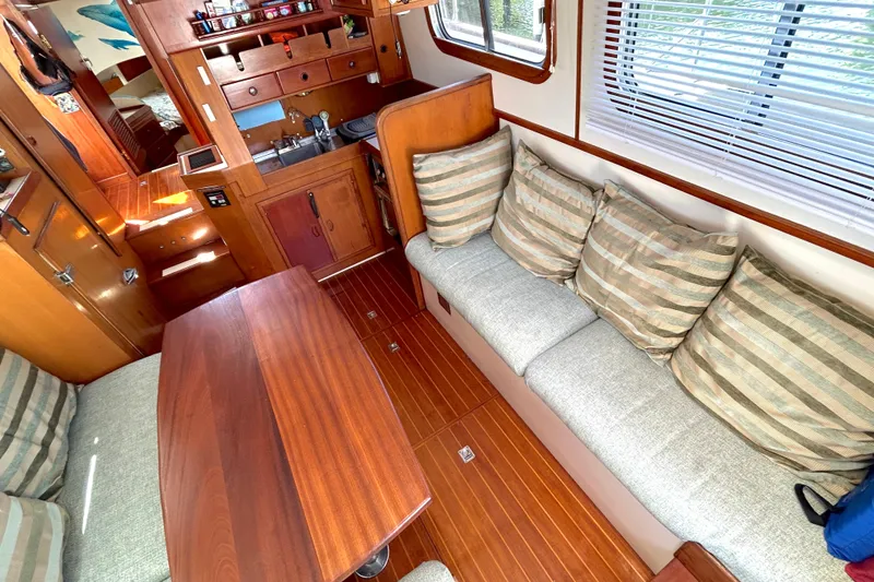 Slide: The Image of Interior of 1987 Transpacific Marine Eagle 32 Trawler with cozy seating and wooden finishes. - 23