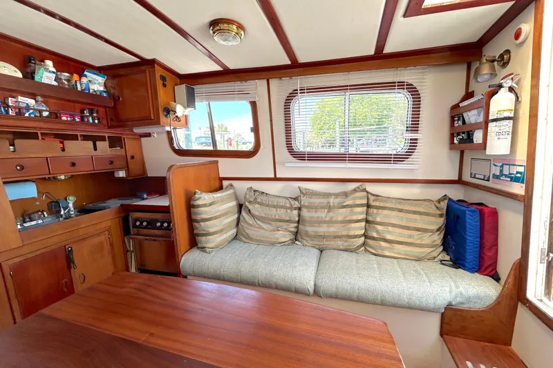 Slide: The Image of Interior of 1987 Transpacific Marine Eagle 32 Trawler with cozy seating and kitchenette. - 26