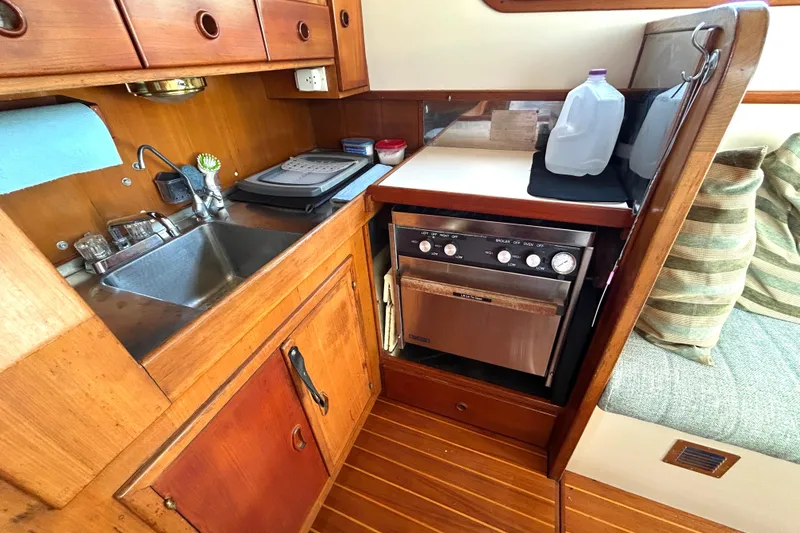 Slide: The Image of 1987 Transpacific Marine Eagle 32 Trawler kitchen with sink, stove, and wooden cabinetry. - 29