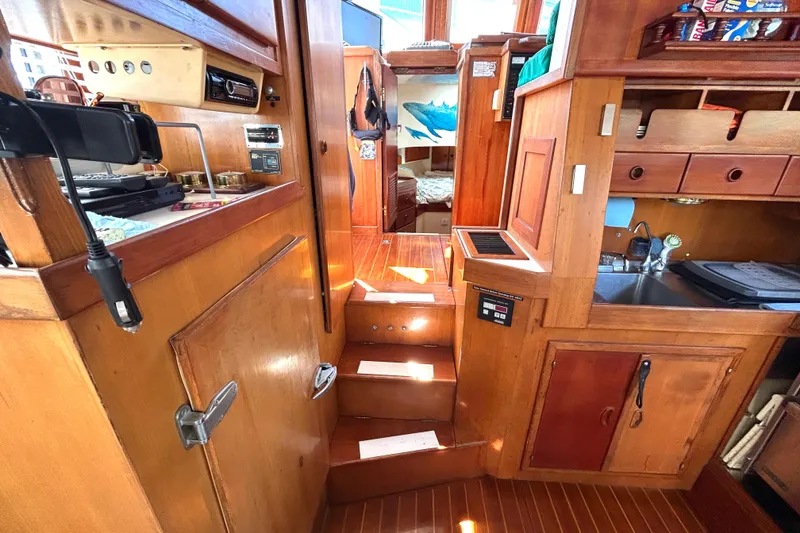 Slide: The Image of Interior of 1987 Transpacific Marine Eagle 32 Trawler with wooden cabinetry and steps. - 30