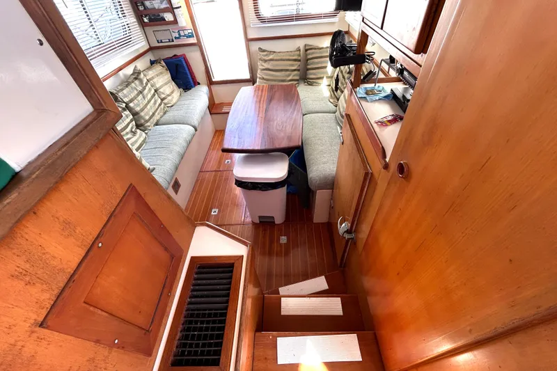 Slide: The Image of Interior of 1987 Transpacific Marine Eagle 32 Trawler with wooden finishes and cozy seating area. - 31