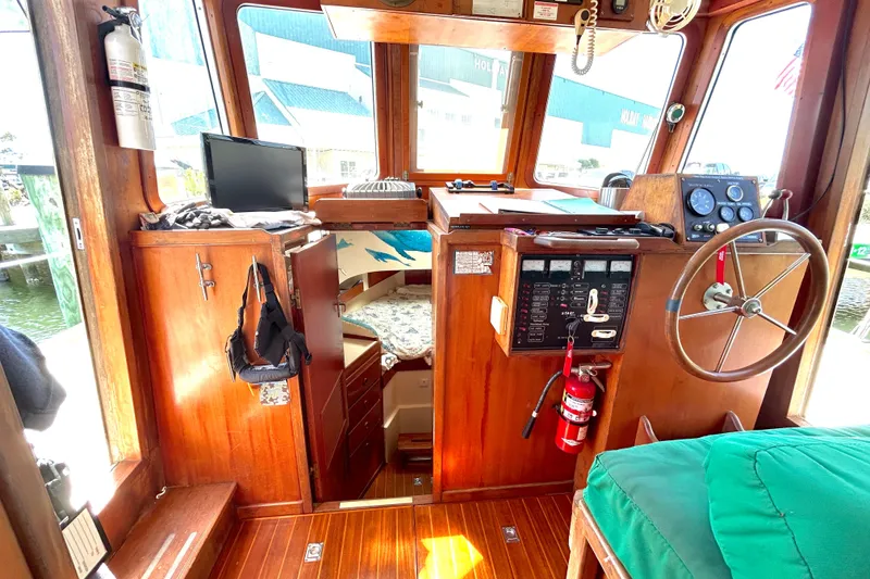 Slide: The Image of Interior of 1987 Transpacific Marine Eagle 32 Trawler with wooden helm and navigation equipment. - 33