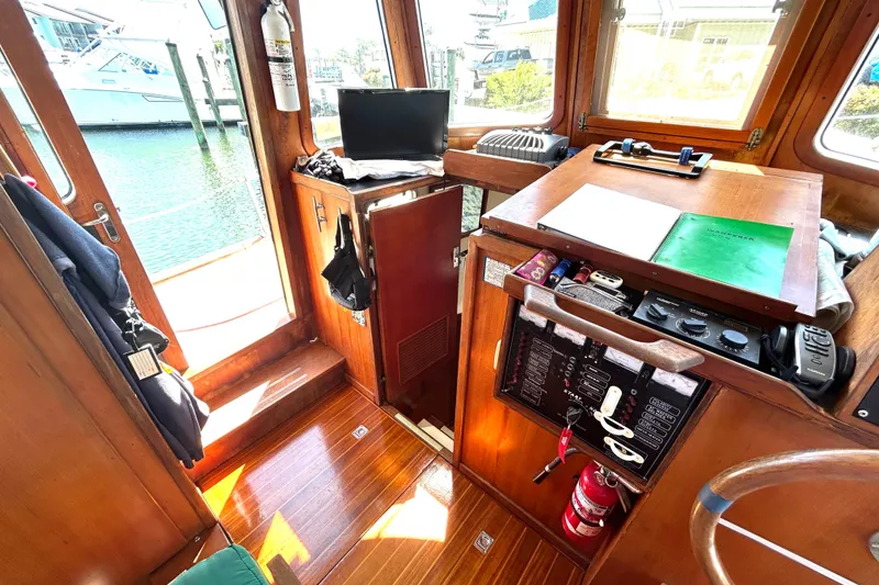 Slide: The Image of 1987 Transpacific Marine Eagle 32 Trawler interior with wooden cabinetry and navigation equipment. - 35