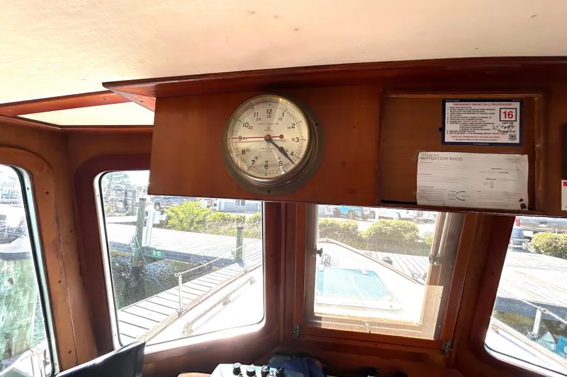 Slide: The Image of Interior of 1987 Transpacific Marine Eagle 32 Trawler with clock and navigation documents. - 41