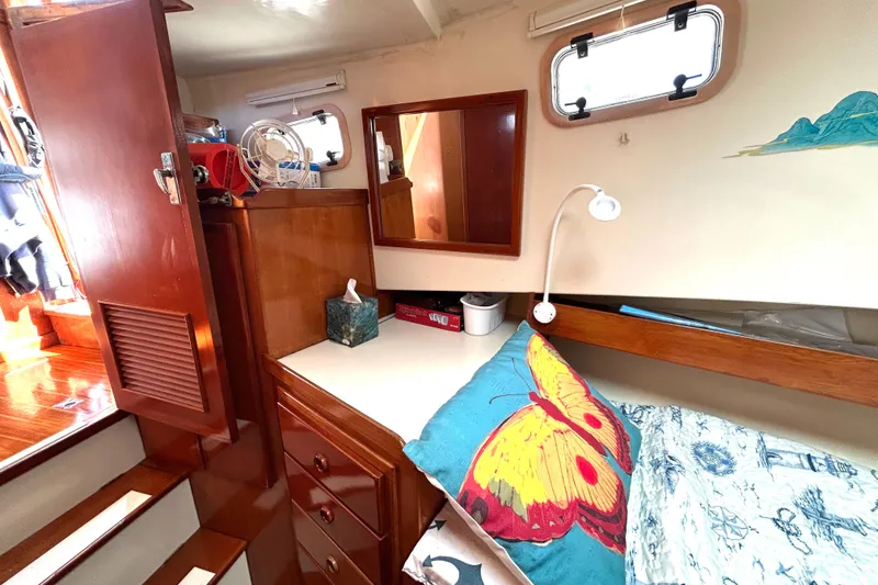 Slide: The Image of Cozy cabin interior of 1987 Transpacific Marine Eagle 32 Trawler with colorful butterfly pillow. - 45