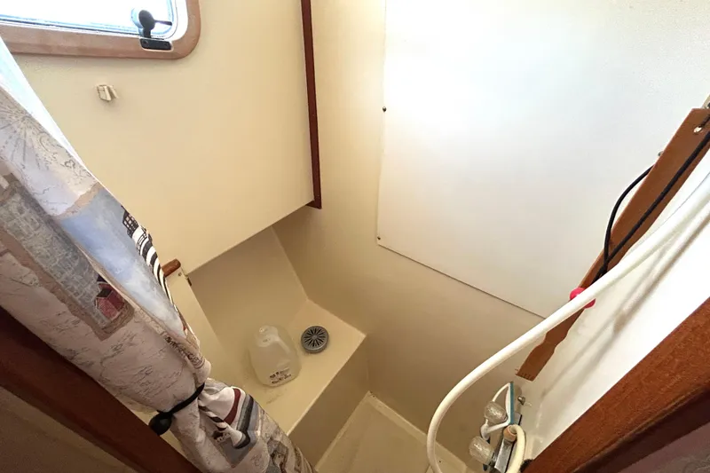 Slide: The Image of 1987 Transpacific Marine Eagle 32 Trawler bathroom with shower and nautical-themed curtain. - 49