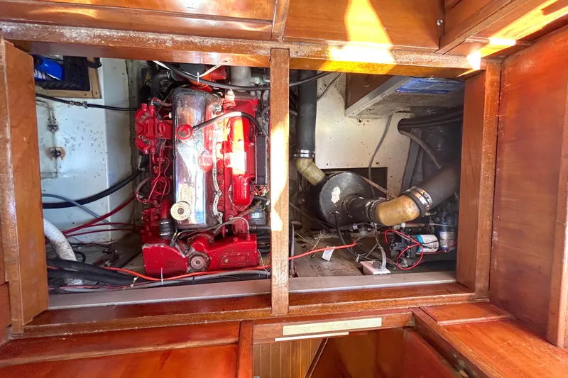 Slide: The Image of Engine compartment of a 1987 Transpacific Marine Eagle 32 Trawler, showcasing red engine and components. - 53