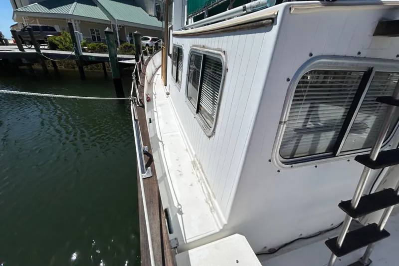 Slide: The Image of 1987 Transpacific Marine Eagle 32 Trawler docked, showcasing side deck and windows. - 8