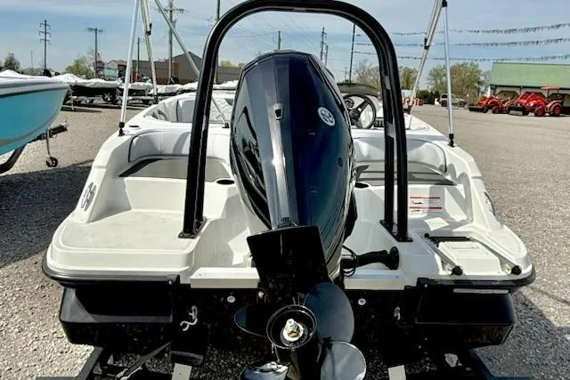 Slide: The Image of 2026 Bayliner M17 boat with outboard motor, displayed in a dealership lot. - 3
