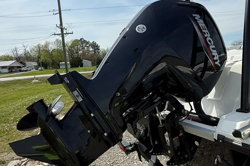 Slide: The Image of 2026 Bayliner M17 with Mercury outboard motor, parked outdoors on a sunny day. - 4