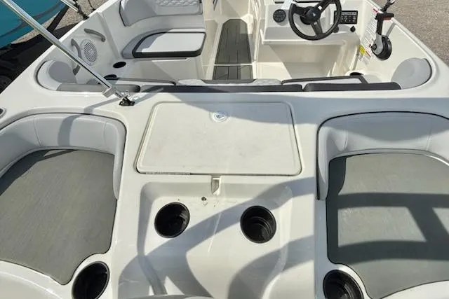 Slide: The Image of 2026 Bayliner M17 boat interior with seating, cup holders, and steering console. - 6