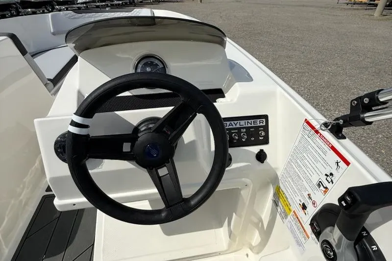Slide: The Image of 2026 Bayliner M17 boat dashboard with steering wheel and control panel. - 8