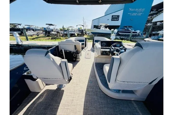 Slide: The Image of 2022 Harris Grand Mariner 250 interior with luxurious seating and modern dashboard. - 10