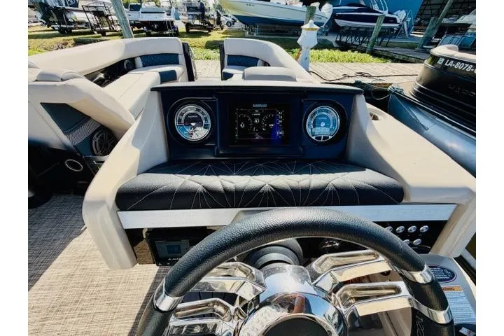 Slide: The Image of 2022 Harris Grand Mariner 250 dashboard with steering wheel and control panel. - 11