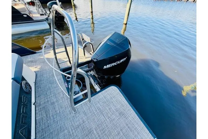 Slide: The Image of 2022 Harris Grand Mariner 250 with Mercury outboard motor on a calm lake. - 14