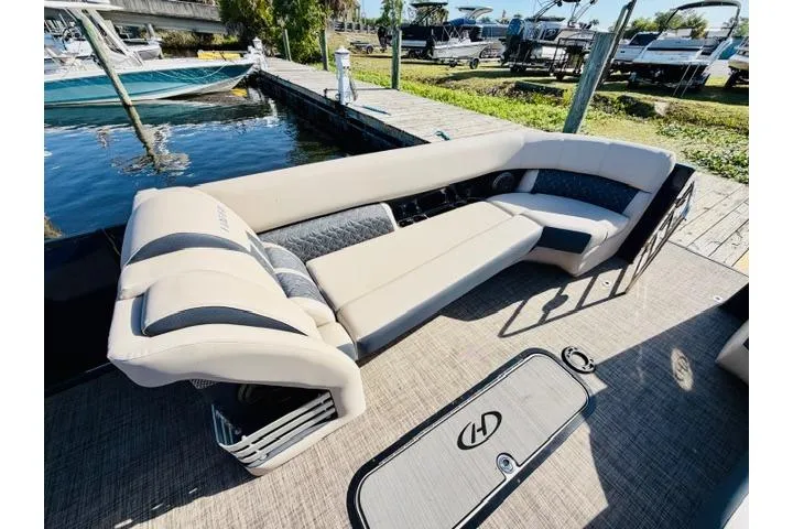Slide: The Image of 2022 Harris Grand Mariner 250 boat interior with plush seating by the dock. - 3
