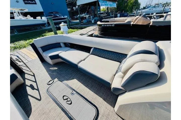 Slide: The Image of 2022 Harris Grand Mariner 250 boat interior with spacious seating and modern design. - 4