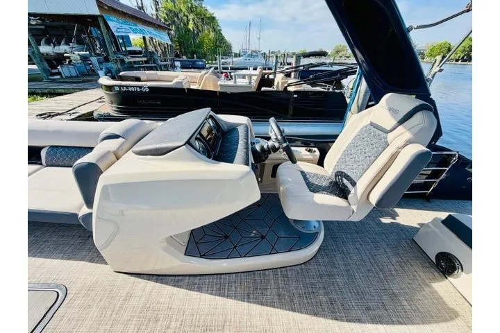 Slide: The Image of 2022 Harris Grand Mariner 250 boat interior with modern helm and seating. - 5