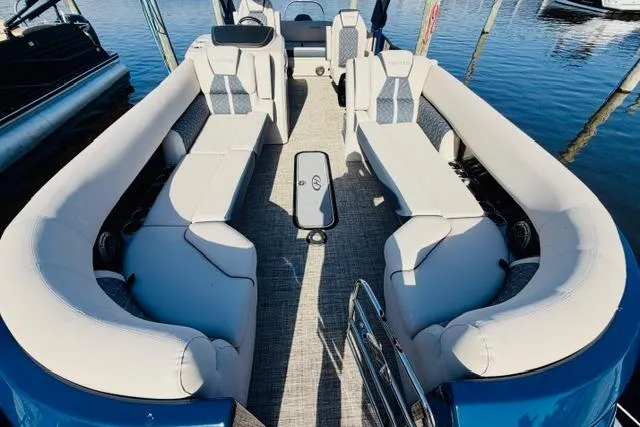 Slide: The Image of 2022 Harris Grand Mariner 250 pontoon boat with spacious seating on calm water. - 9