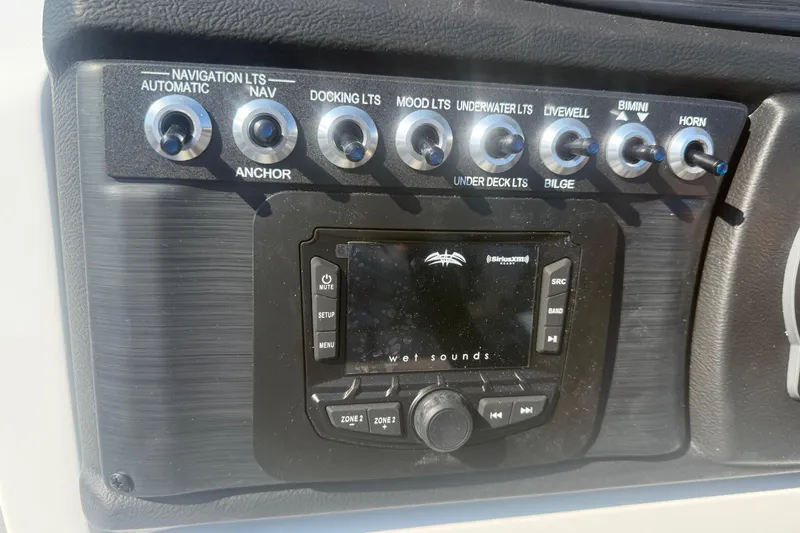 Slide: The Image of Control panel of 2026 Berkshire CTS Series 24RFX CTS boat with switches and audio system. - 10