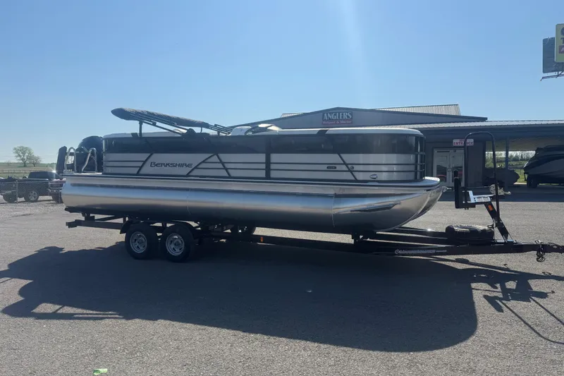Slide: The Image of 2026 Berkshire CTS Series 24RFX pontoon boat on trailer in sunny outdoor setting. - 3