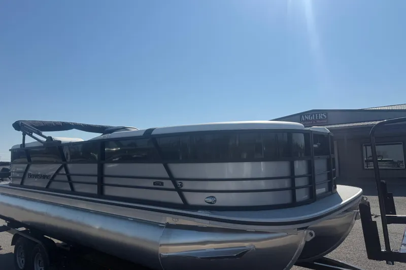 Slide: The Image of 2026 Berkshire CTS Series 24RFX pontoon boat on trailer under clear blue sky. - 4