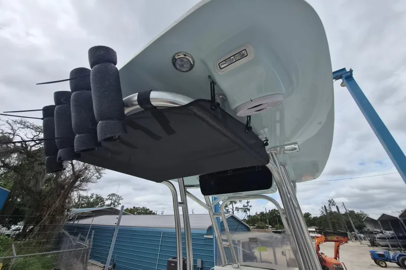 Slide: The Image of 2026 Key West 219 FS boat with rod holders and T-top, docked outdoors. - 11