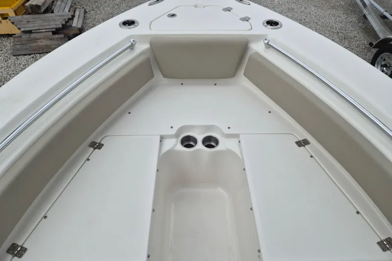 Slide: The Image of 2026 Key West 219 FS boat interior with storage compartments and cup holders. - 13