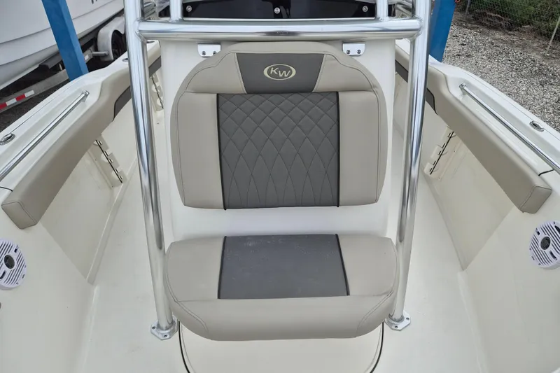 Slide: The Image of 2026 Key West 219 FS boat interior with cushioned seating and stainless steel railings. - 14