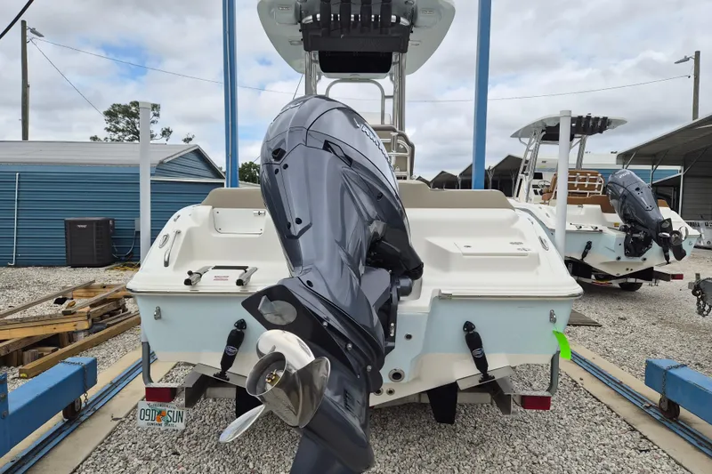 Slide: The Image of 2026 Key West 219 FS boat with outboard motor in a marina setting. - 3