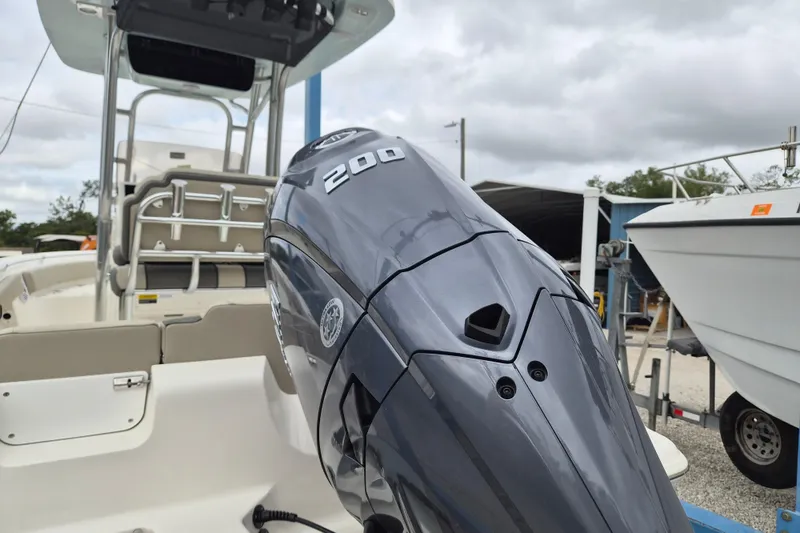 Slide: The Image of 2026 Key West 219 FS boat with powerful 200 HP engine, docked outdoors. - 4