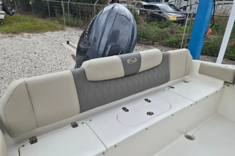Slide: The Image of 2026 Key West 219 FS boat interior with cushioned seating and storage compartments. - 5