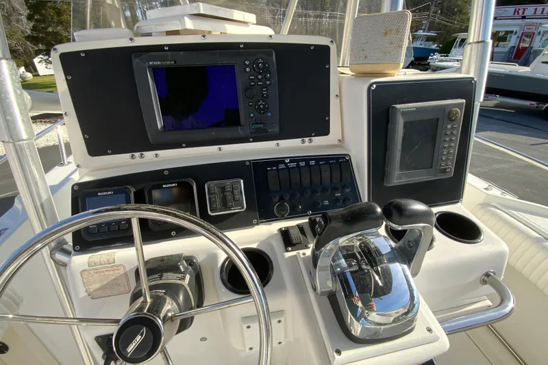 Slide: The Image of Boston Whaler 26 Outrage 2000 helm with steering wheel, controls, and navigation equipment. - 14