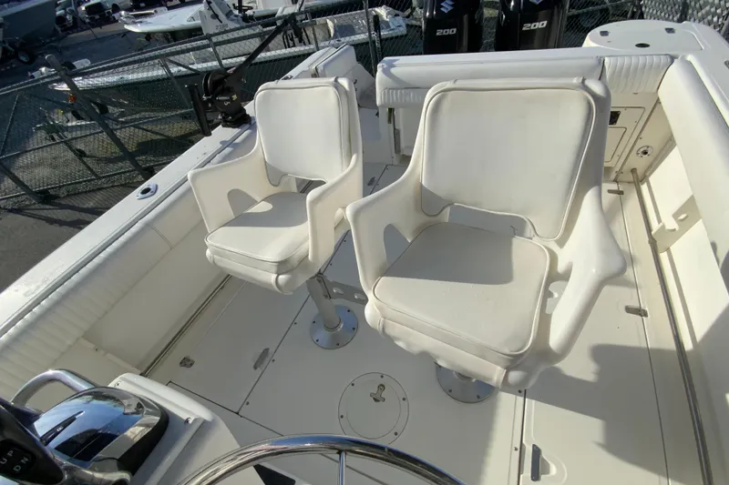 Slide: The Image of Boston Whaler 26 Outrage 2000 boat interior with two white swivel chairs. - 15