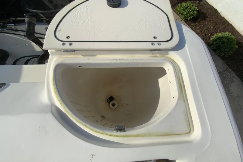Slide: The Image of Open storage compartment on a 2000 Boston Whaler 26 Outrage boat. - 17