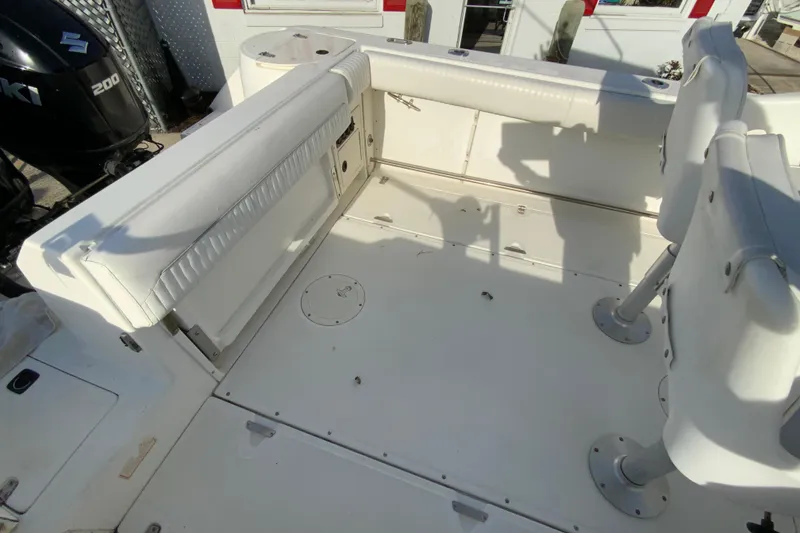 Slide: The Image of 2000 Boston Whaler 26 Outrage boat interior with seating and Suzuki 200 engine. - 18