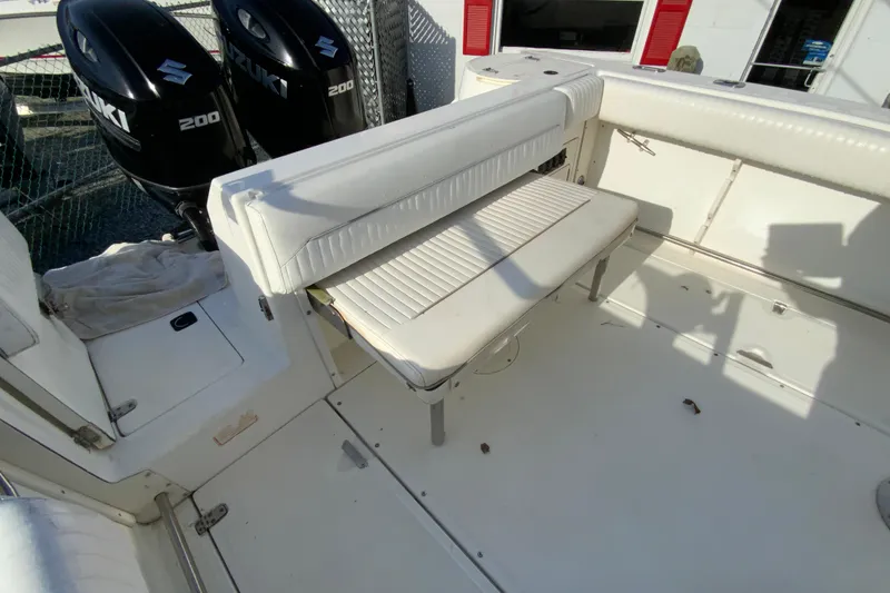 Slide: The Image of 2000 Boston Whaler 26 Outrage boat interior with Suzuki 200 engines and white seating. - 19