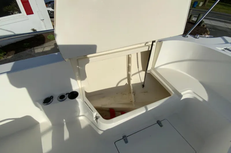 Slide: The Image of Open storage compartment on a 2000 Boston Whaler 26 Outrage boat deck. - 23