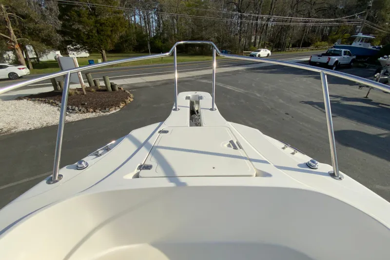 Slide: The Image of Bow view of 2000 Boston Whaler 26 Outrage boat in a parking area. - 24