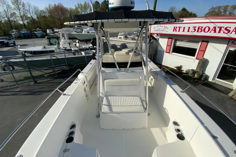 Slide: The Image of 2000 Boston Whaler 26 Outrage boat at dealership, featuring center console and seating. - 26