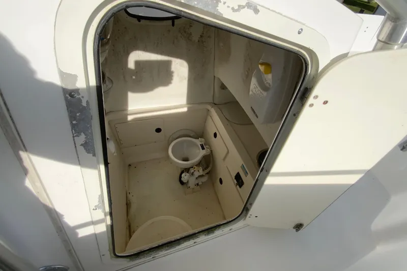 Slide: The Image of Interior view of a 2000 Boston Whaler 26 Outrage boat's compact bathroom. - 27