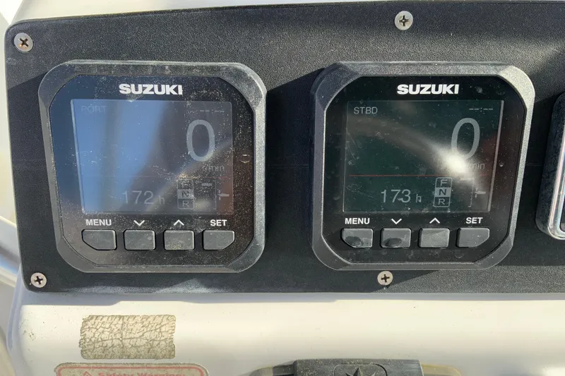 Slide: The Image of Suzuki engine displays on a 2000 Boston Whaler 26 Outrage boat dashboard. - 29