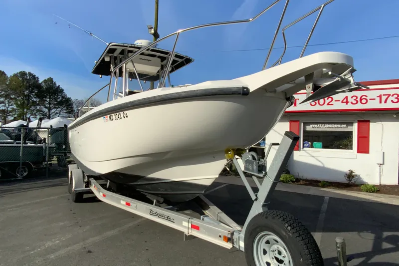 Slide: The Image of 2000 Boston Whaler 26 Outrage boat on trailer, parked outdoors. - 3