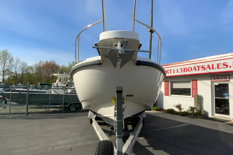 Slide: The Image of 2000 Boston Whaler 26 Outrage boat on trailer at dealership, clear sky background. - 4