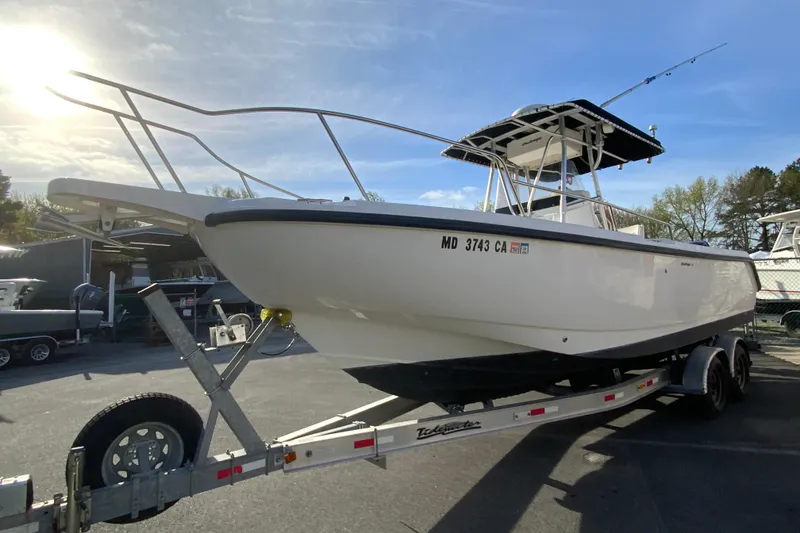 Slide: The Image of 2000 Boston Whaler 26 Outrage boat on trailer under sunny sky. - 5