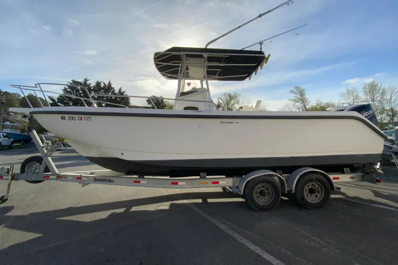 Slide: The Image of 2000 Boston Whaler 26 Outrage boat on trailer, side view, sunny day. - 6