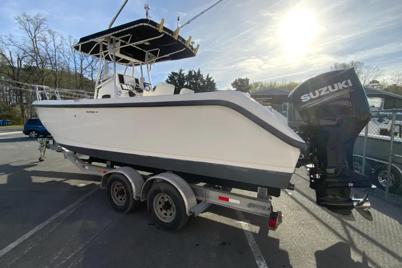 Slide: The Image of Boston Whaler 26 Outrage 2000 boat on trailer with Suzuki outboard motor. - 7