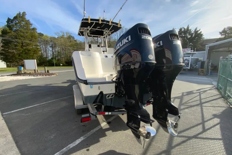 Slide: The Image of Boston Whaler 26 Outrage 2000 with dual Suzuki engines on trailer. - 8