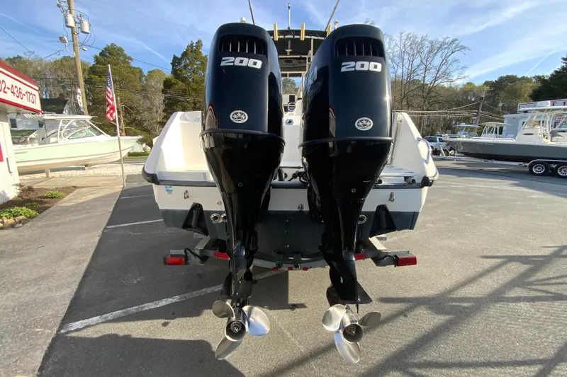 Slide: The Image of 2000 Boston Whaler 26 Outrage with dual 200 horsepower engines, parked outdoors. - 9