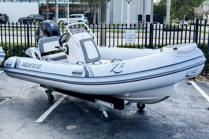 The Image of 2024 Highfield Classic 420 inflatable boat displayed outdoors on a trailer. - 0